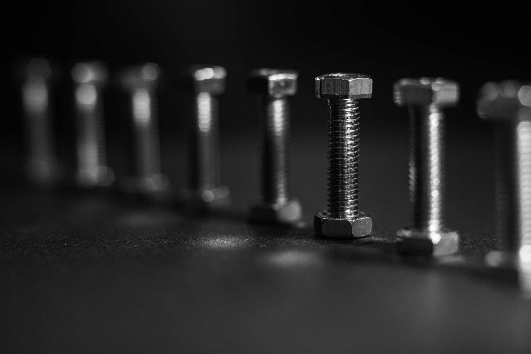 Metal bolts standing in a row